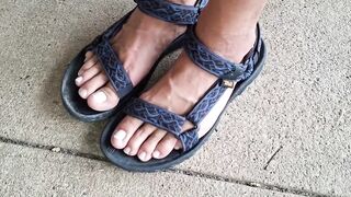 My hunk pedicured feet in sandals