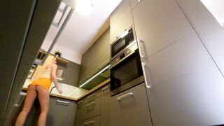 Lengthy hair lengthy legs sexy blond college cutie on high heels and a miniskirt which does not cover her butt in the kitchen