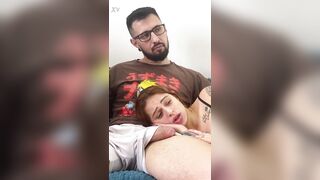 Sexy redhead roommate lies in nerd's lap whilst watching a video and sucks him off until this guy cums hard on her face!