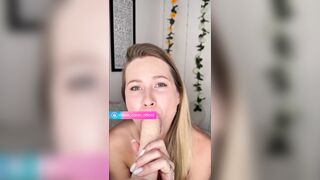 Golden-haired sucks large sex-toy on camera