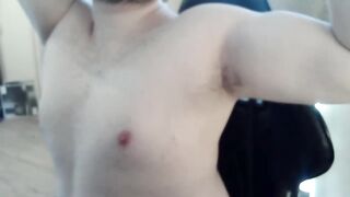 Athletic guy plays with his teats and muscles