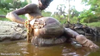 Sexy slim Afro village woman bathing and teasing in a river