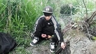 Cute Oriental homosexual twink in a ebony-and-white adidas tracksuit and Campus sneakers masturbates and cums outdoors