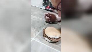 Chubby big beautiful woman piggy eating burger off the floor hands-free
