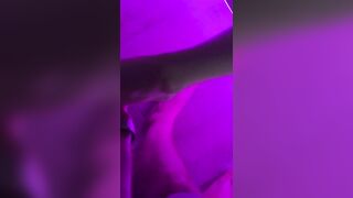 Below the purple light, this guy couldn't take his hands off her feet