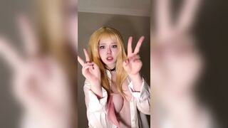 Golden-haired hair frames her face as that babe points the one and the other fingers forward ?
