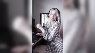 Blond leans back in her chair pulling her shirt up slow