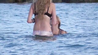 Beach beauty goes for swimming in pants - see out