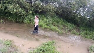 gal has joy in the mud in a blue costume