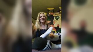Sexy blond teases with socked feet and then tickles herself