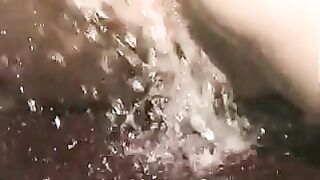 Exposed brunette hair gets twat sprayed with water outside