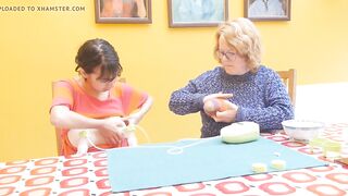 Old woman teaching youthful woman to pump breast milk